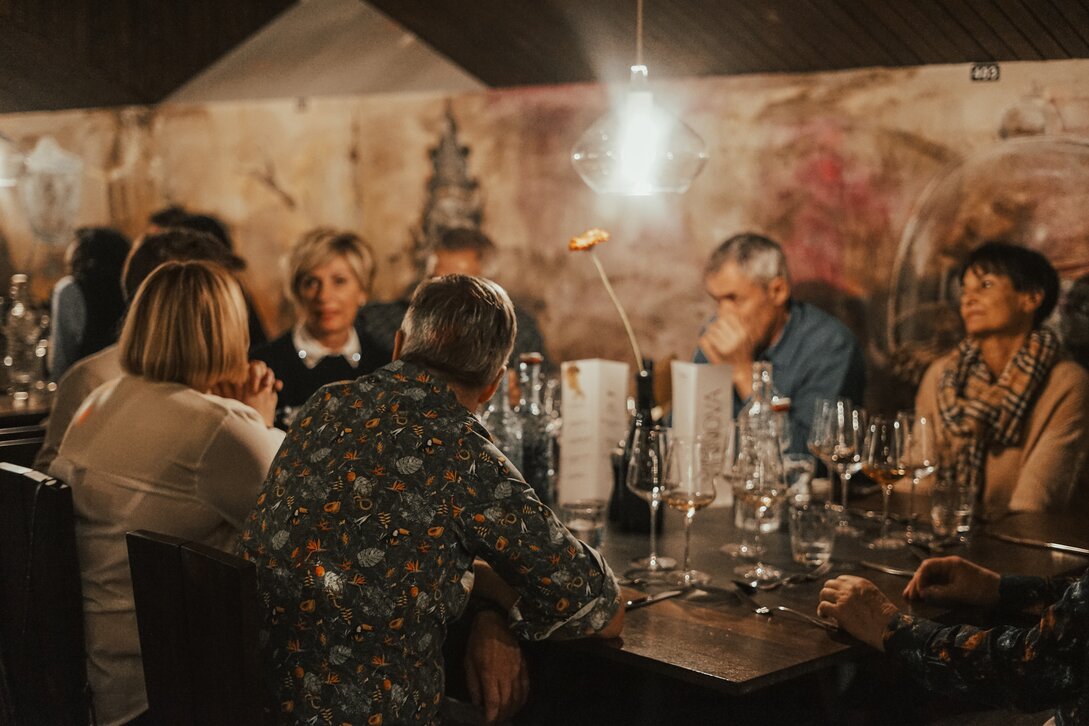 Ein Tisch mit einer Gruppe von Personen beim Winzerabend in der VINNOVA im Skigebiet Silvretta Montafon. | © Vanessa Strauch - Silvretta Montafon