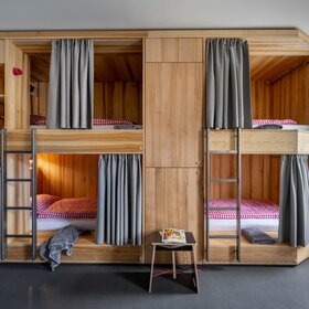 Ein Bett im Mehrbettzimmer mit zwei Stockebetten im Josefsheim Hostel in Schruns. | © Silvretta Montafon - blateral