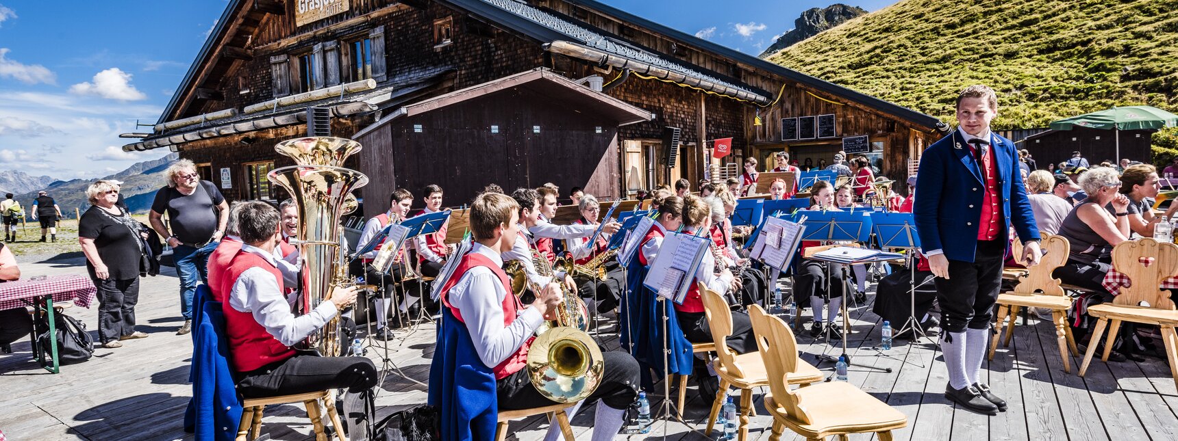 Blasmusikanten spielen auf der Terrasse beim Frühschoppen in der Grasjoch Hütte. | © Silvretta Montafon - Marcel Mehrling