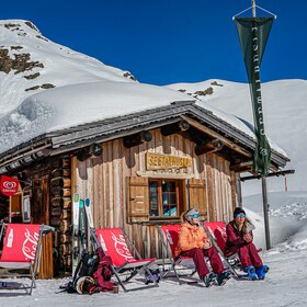 Seetalhüsli - Silvretta Montafon | © Silvretta Montafon - Vanessa Strauch Zwei Frauen sonnen sich am Seetalhüsli nach dem Skifahren. | © Silvretta Montafon - Vanessa Strauch