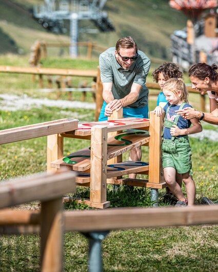 Eine Familie spielt an den Kugelbahnen in der Alpenwelt Nova in der Silvretta Montafon. | © Silvretta Montafon - Stefan Kothner