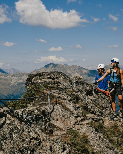 Eine Frau und ein Mann genießen die Aussicht am Klettersteig Madrisella. | © Silvretta Montafon - Vanessa Strauch